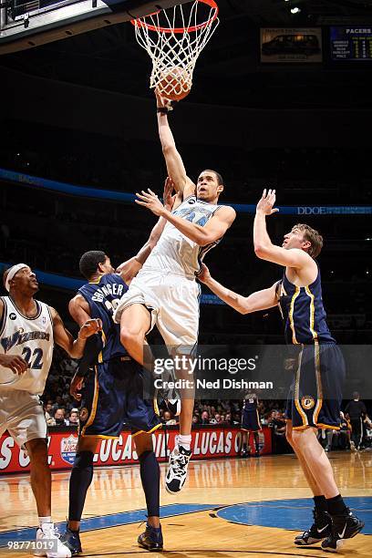 JaVale McGee of the Washington Wizards drives the lane for a jump shot against Danny Granger and Troy Murphy of the Indiana Pacers during the game at...