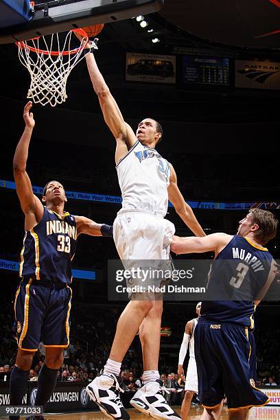 JaVale McGee of the Washington Wizards lays up a shot against Danny Granger and Troy Murphy of the Indiana Pacers during the game at the Verizon...