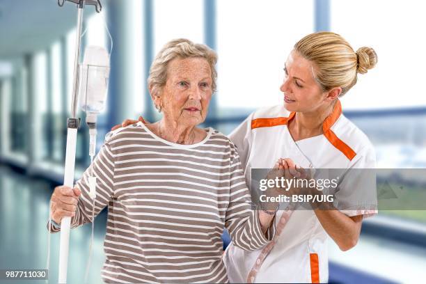 senior woman and auxiliary nurse. - bsip stock pictures, royalty-free photos & images