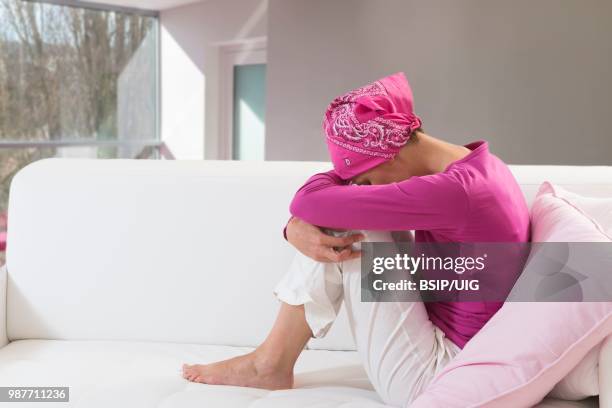 sad woman wearing a headscarf. - bsip stockfoto's en -beelden