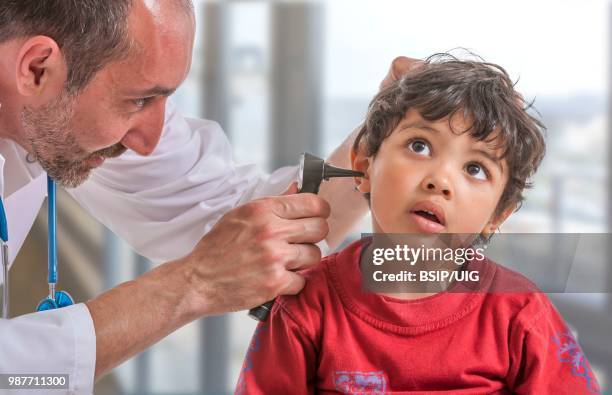 doctor examining a child's ear. - bsip stock pictures, royalty-free photos & images