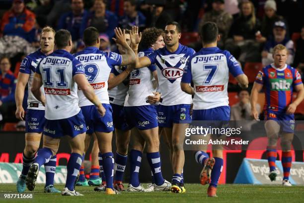 Kerrod Holland of the Bulldogs celebrates his try with team mates during the round 10 NRL match between the Newcastle Knights and the Penrith...