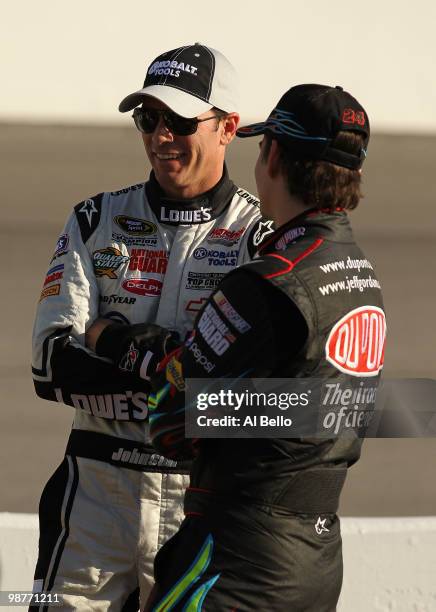 Jimmie Johnson , driver of Lowe's / Kobalt tools Chevrolet speaks to Jeff Gordon, driver of Dupont Chevrolet on the grid during qualifying for the...