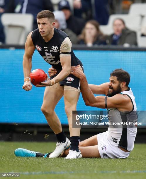 Marc Murphy of the Blues is tackled by Paddy Ryder of the Power during the 2018 AFL round15 match between the Carlton Blues and the Port Adelaide...