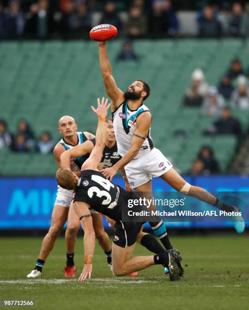 Paddy Ryder of the Power and Andrew Phillips of the Blues compete in a ruck contest during the 2018 AFL round15 match between the Carlton Blues and...