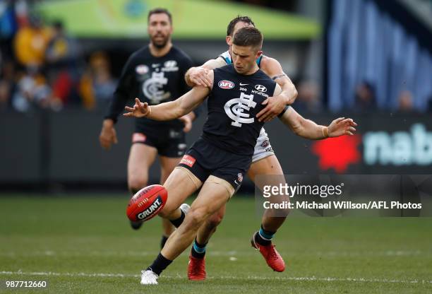 Marc Murphy of the Blues is tackled by Travis Boak of the Power during the 2018 AFL round15 match between the Carlton Blues and the Port Adelaide...