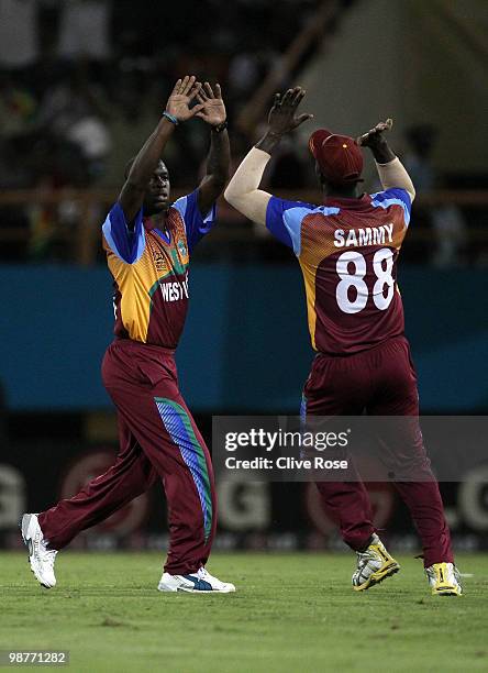 Kemar Roach of West Indies celebrates with Darren Samy after taking the wicket of William Porterfield of Ireland during the ICC T20 World Cup Group D...