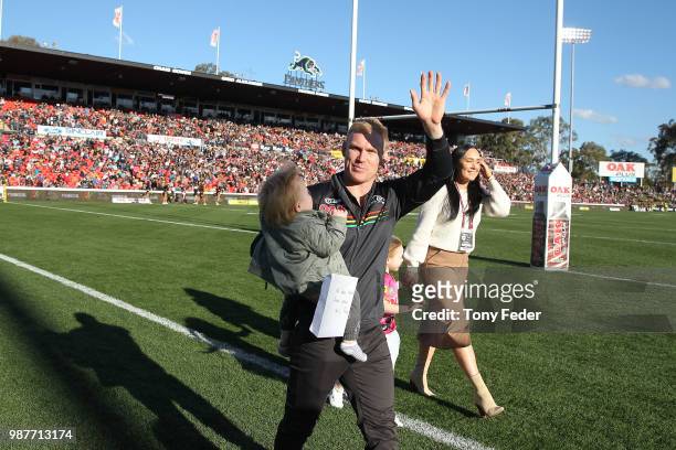 Former Panthers player Peter Wallace waves to the crowd while doing a lap of the ground during the round 16 NRL match between the Penrith Panthers...