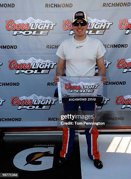 Kyle Busch, driver of the M&M's Toyota, holds up his pole ward after he qualified first for the NASCAR Sprint Cup Series Crown Royal presents the...