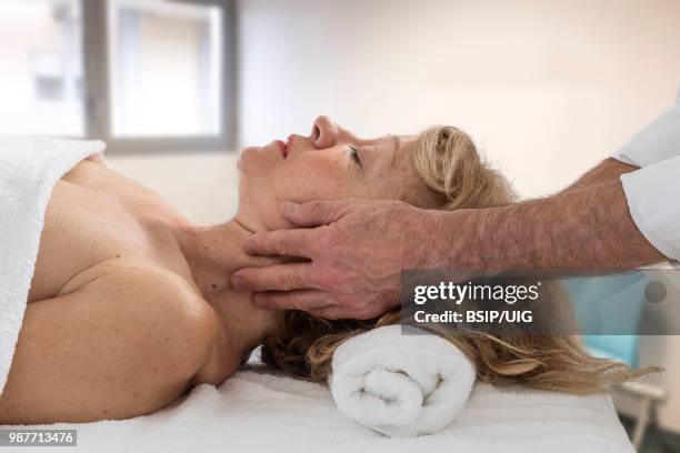 senior woman having massage. - bsip stockfoto's en -beelden