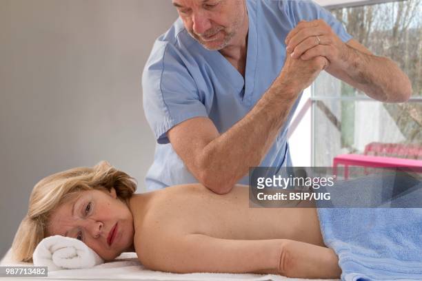 senior woman having massage. - bsip stock pictures, royalty-free photos & images