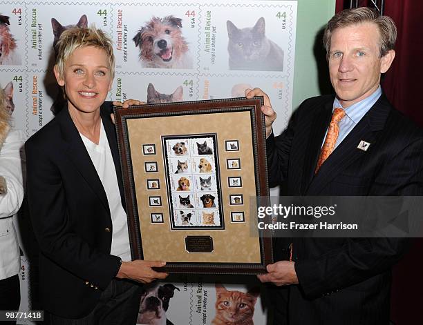 Actress and talk show host Ellen DeGeneres poses with Joseph Corbett, United States Postal Service Chief Financial Officer and Executive Vice...