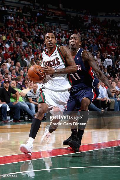 Brandon Jennings of the Milwaukee Bucks drives to the basket past Jamal Crawford of the Atlanta Hawks in Game Four of the Eastern Conference...