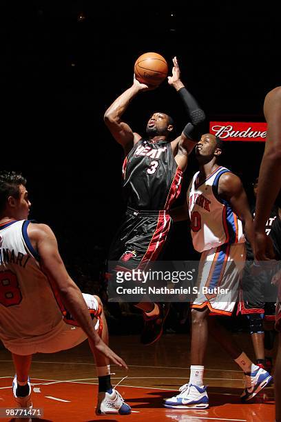 Dwyane Wade of the Miami Heat goes up for a shot against Danilo Gallinari and Earl Barron of the New York Knicks during the game at Madison Square...