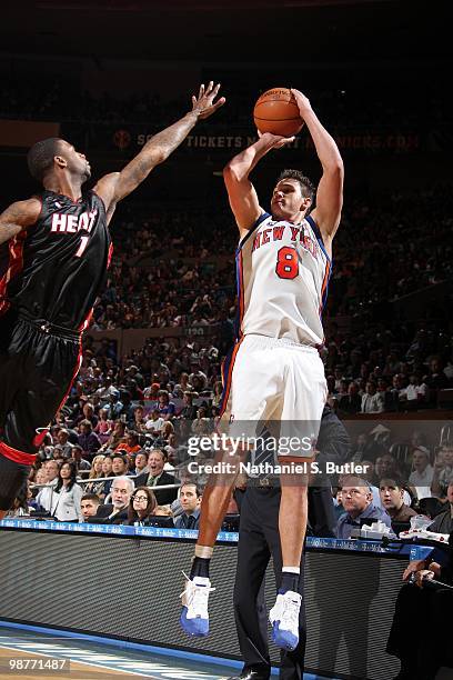 Danilo Gallinari of the New York Knicks shoots a jump shot against Dorell Wright of the Miami Heat during the game at Madison Square Garden on April...