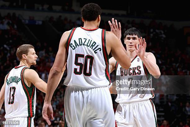 Luke Ridnour, Dan Gadzuric and Ersan Ilyasova of the Milwaukee Bucks celebrate a play in Game Four of the Eastern Conference Quarterfinals against...