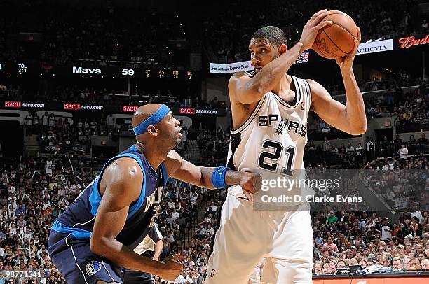 Tim Duncan of the San Antonio Spurs handles the ball against Erick Dampier of the Dallas Mavericks in Game Six of the Western Conference...