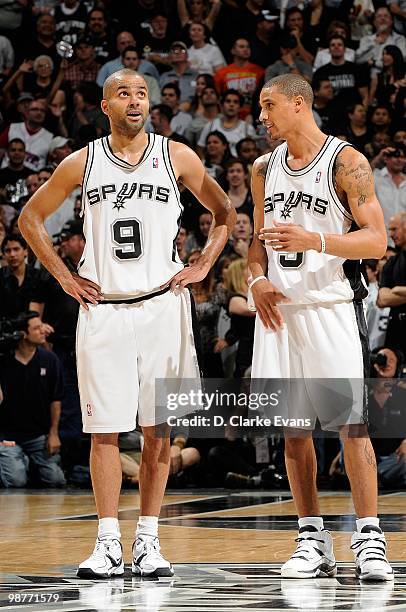 Tony Parker and George Hill of the San Antonio Spurs stand on the court in Game Six of the Western Conference Quarterfinals against the Dallas...