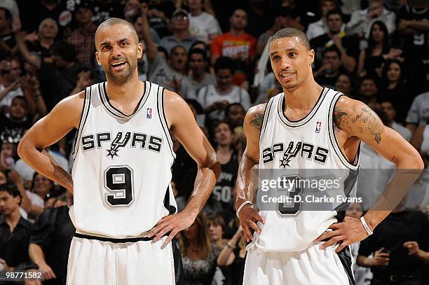 Tony Parker and George Hill of the San Antonio Spurs smile on the court in Game Six of the Western Conference Quarterfinals against the Dallas...