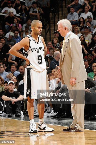 Tony Parker and head coach Gregg Popovich of the San Antonio Spurs talk in Game Six of the Western Conference Quarterfinals against the Dallas...