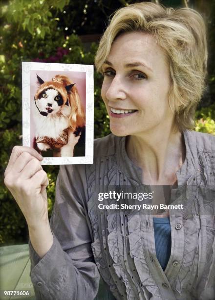 Star of the TV show 'Glee' Jane Lynch poses for a portrait with a photo of a feline Madonna impersonator on April 23, 2010 in Los Angeles, California.