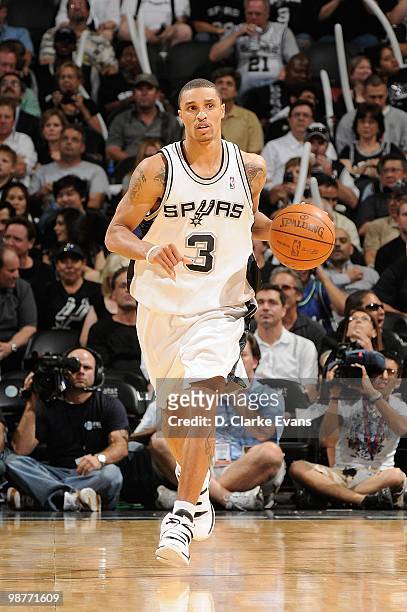 George Hill of the San Antonio Spurs brings the ball upcourt against the Dallas Mavericks in Game Six of the Western Conference Quarterfinals during...