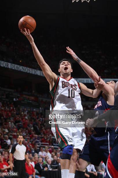Carlos Delfino of the Milwaukee Bucks shoots a layup against Mike Bibby of the Atlanta Hawks in Game Six of the Eastern Conference Quarterfinals...
