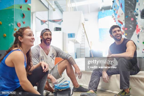 happy wall climbers looking away in gym - climbing wall stock pictures, royalty-free photos & images