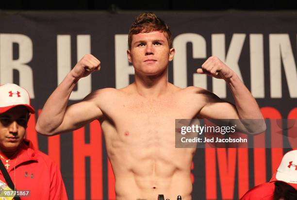 Saul Alvarez of Mexico poses afer he steps on the scale during the weigh-in for his bout against Jose Miguel Cotto of Puerto Rico at the MGM Grand...