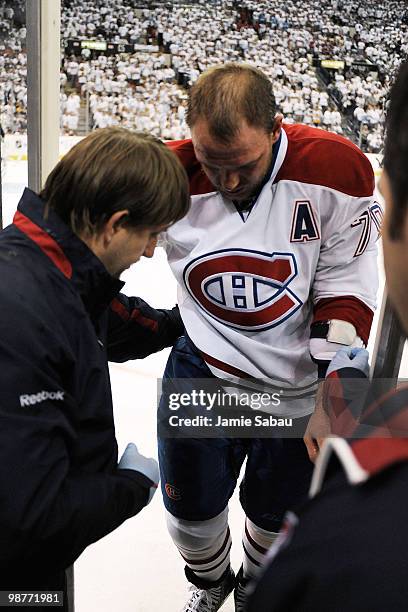 Andrei Markov of the Montreal Canadiens is assisted off the ice to the dressing room after being injured in the first period against the Pittsburgh...