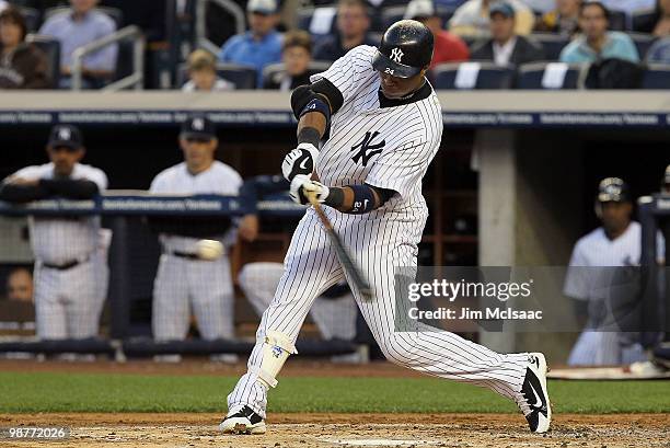 Robinson Cano of the New York Yankees connects on a first inning RBI single against the Chicago White Sox on April 30, 2010 at Yankee Stadium in the...