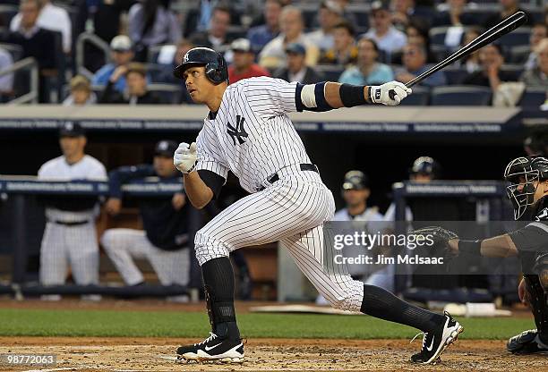 Alex Rodriguez of the New York Yankees follows through on his first inning RBI double against the Chicago White Sox on April 30, 2010 at Yankee...