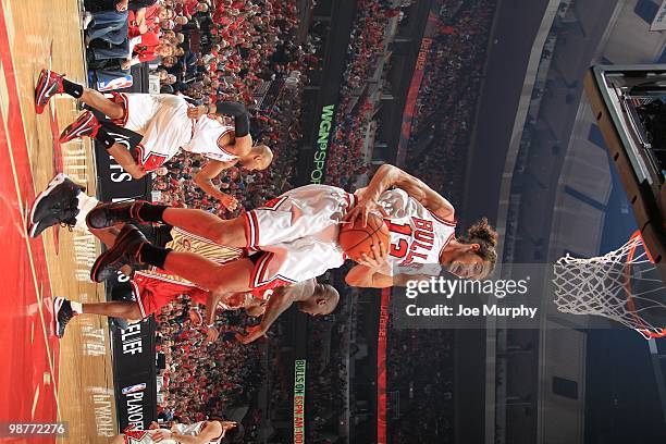 Joakim Noah of the Chicago Bulls rebounds the ball against the Cleveland Cavaliers in Game Four of the Eastern Conference Quarters during the 2010...