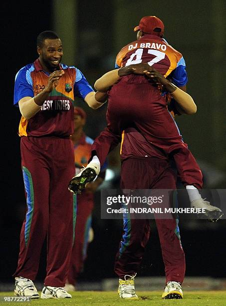 West Indies cricketers West Indies cricketers Kieron Pollard and Dwayne Bravo celebrates with Darren Sammy the wicket of George Dockrell of Ireland...