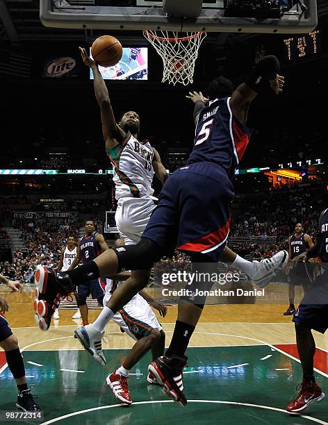 John Salmons of the Milwaukee Bucks puts up a shot against Josh Smith of the Atlanta Hawks in Game Six of the Eastern Conference Quarterfinals during...