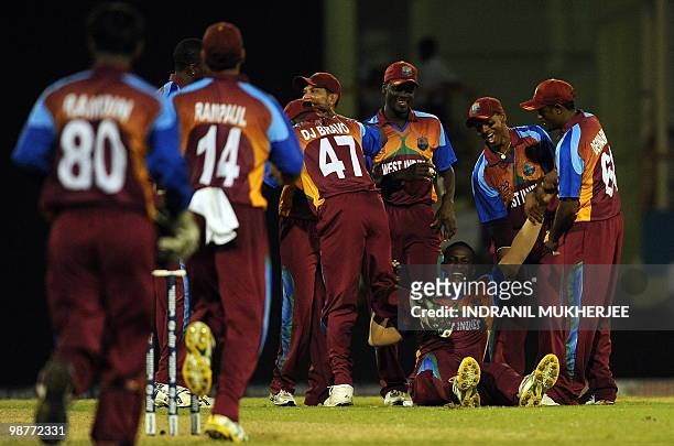 West Indies cricketers greet teammate Darren Sammy for the wicket of George Dockrell of Ireland and their victory during their ICC World Twenty20...