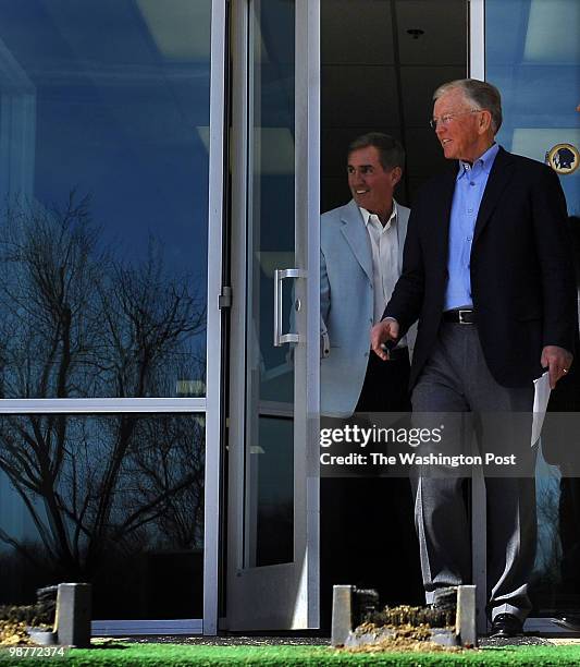 Washington Redskins coach Mike Shanahan, left, and former coach Joe Gibbs walk out of the Redskins building to a press conference at Redskins Park in...