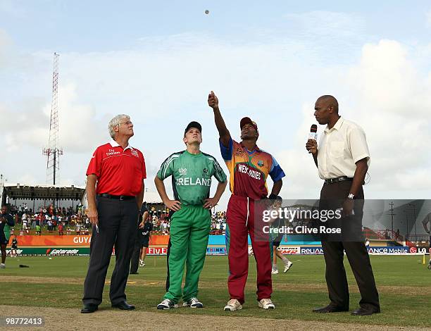 Dwayne Bravo of West Indies and William Porterfield of Ireland complete the toss prior to the ICC T20 World Cup Group D match between West Indies and...