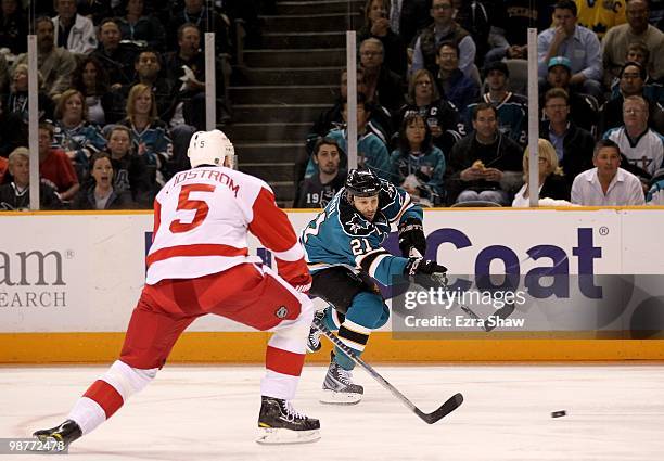Scott Nichol of the San Jose Sharks shoots past Nicklas Lidstrom of the Detroit Red Wings in Game One of the Western Conference Semifinals during the...