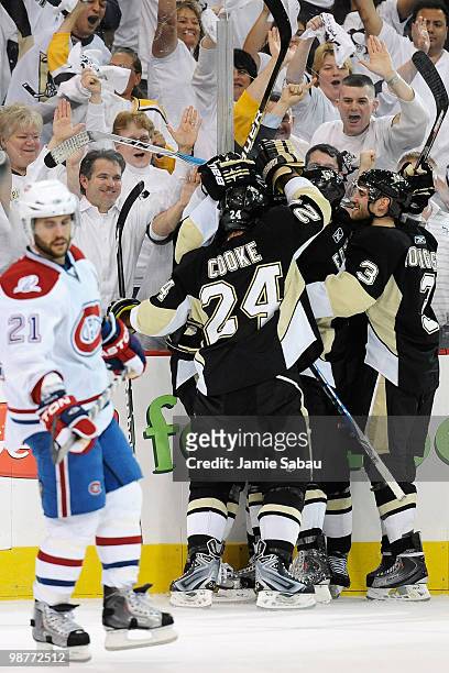 Brian Gionta of the Montreal Canadiens skates by as the Pittsburgh Penguins celebrate a goal by Craig Adams of the Penguins in the second period in...