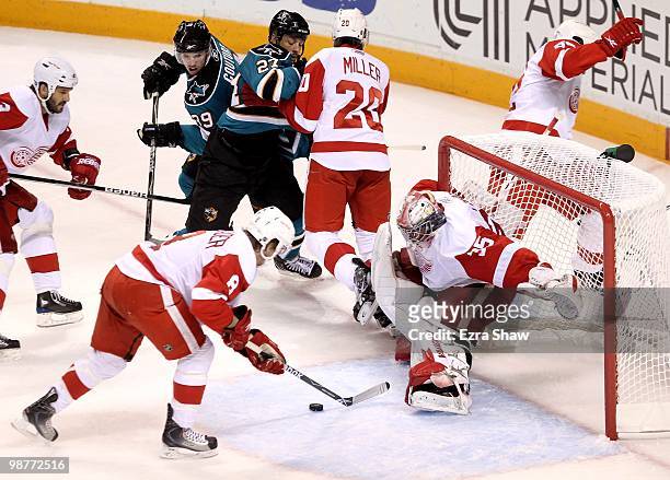 Justin Abdelkader and goalie Jimmy Howard of the Detroit Red Wings make a save during their game against the San Jose Sharks in Game One of the...