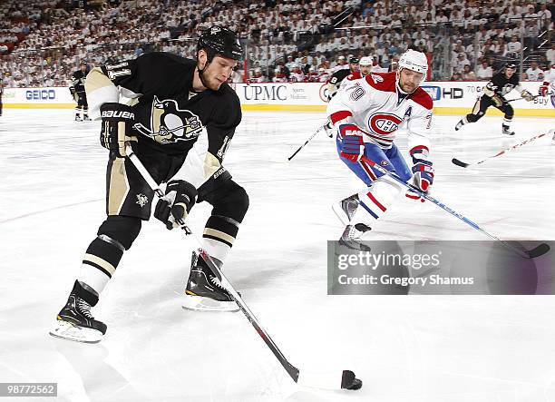 Jordan Staal of the Pittsburgh Penguins moves the puck in front of Andrei Markov of the Montreal Canadiens in Game One of the Eastern Conference...