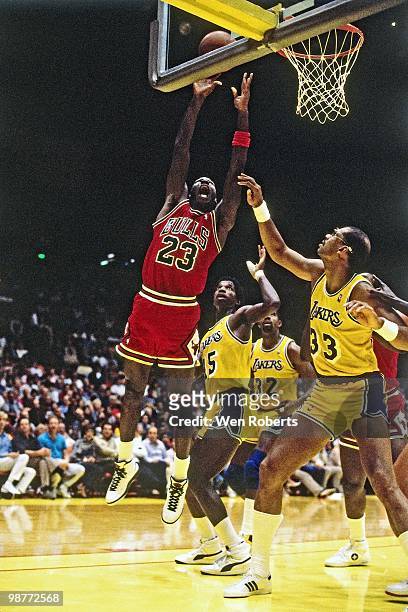 Michael Jordan of the Chicago Bulls shoots against Kareem Abdul-Jabbar of the Los Angeles Lakers during a game played circa 1986 at the Great Western...