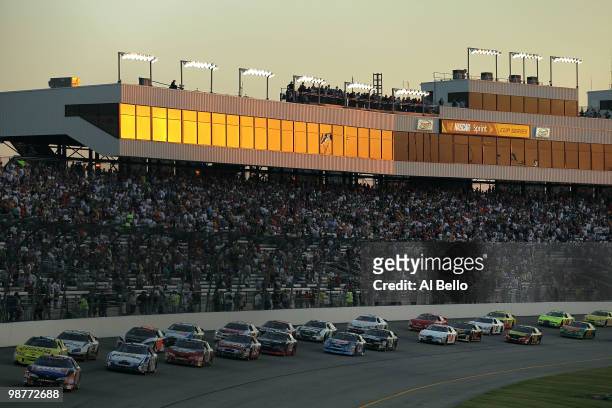 Kyle Busch, driver of the NOS Energy Drink Toyota, leads the field at the start of the NASCAR Nationwide Series BUBBA burger 250 at Richmond...