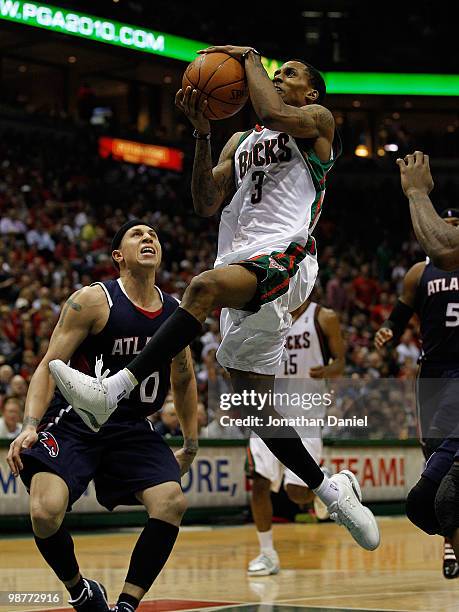 Brandon Jennings of the Milwaukee Bucks drives to the basket past Mike Bibby of the Atlanta Hawks in Game Six of the Eastern Conference Quarterfinals...