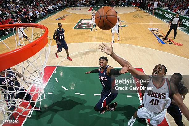 Josh Smith of the Atlanta Hawks reaches for a rebound against Kurt Thomas of the Milwaukee Bucks in Game Six of the Eastern Conference Quarterfinals...
