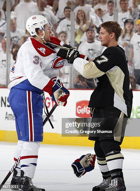 Mark Eaton of the Pittsburgh Penguins scuffles with Travis Moen of the Montreal Canadiens in Game One of the Eastern Conference Semifinals during the...