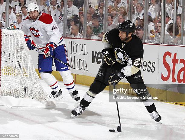 Maxime Talbot of the Pittsburgh Penguins moves the puck in front of Roman Hamrlik of the Montreal Canadiens in Game One of the Eastern Conference...