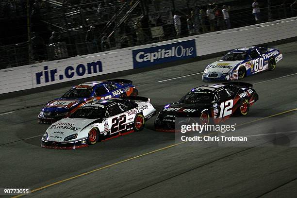 Brad Keselowski, driver of the Ruby Tuesday Dodge, leads Kyle Busch, driver of the NOS Energy Drink Toyta, Justin Allgaier, driver of the Verizon...
