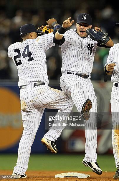 Robinson Cano and Nick Swisher of the New York Yankees celebrate after defeating the Chicago White Sox on April 30, 2010 at Yankee Stadium in the...